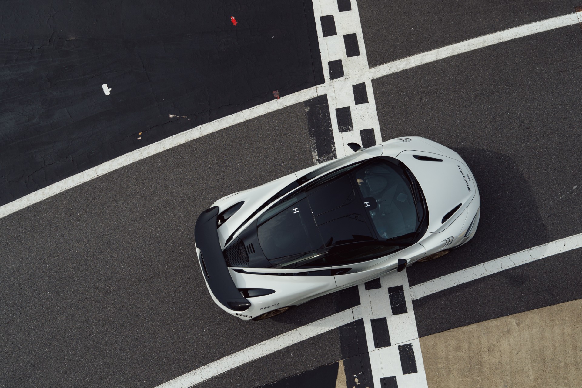 White McLaren on the Silverstone circuit start-finish line